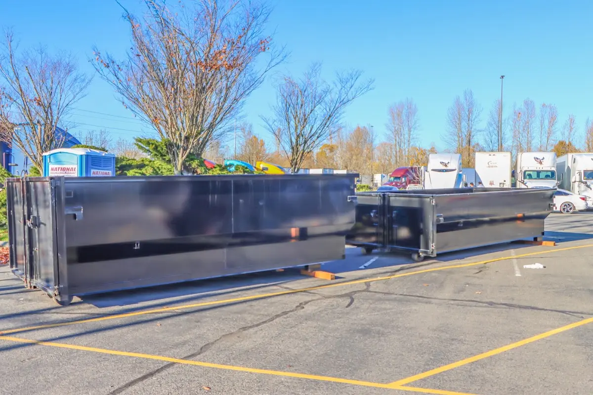 Professional dumpster rental service with roll-off container on residential driveway in North Coventry